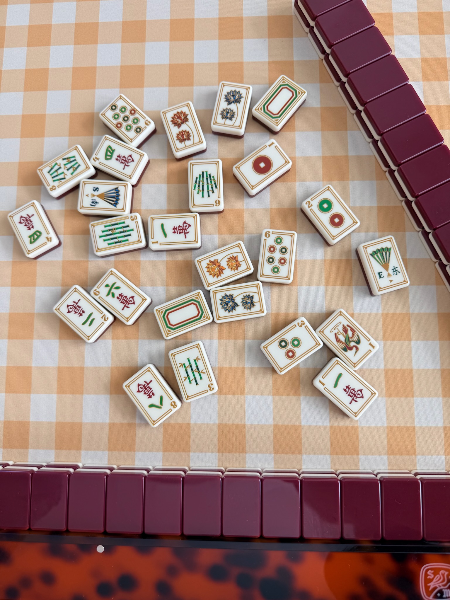 Vintage jade and ivory mahjong tiles on warm linen